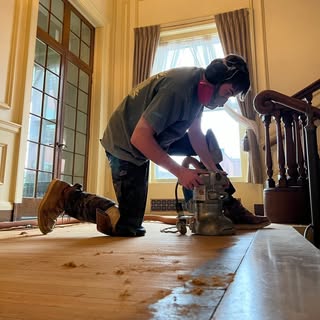 Will from Detail Refinishing sanding a hardwood floor